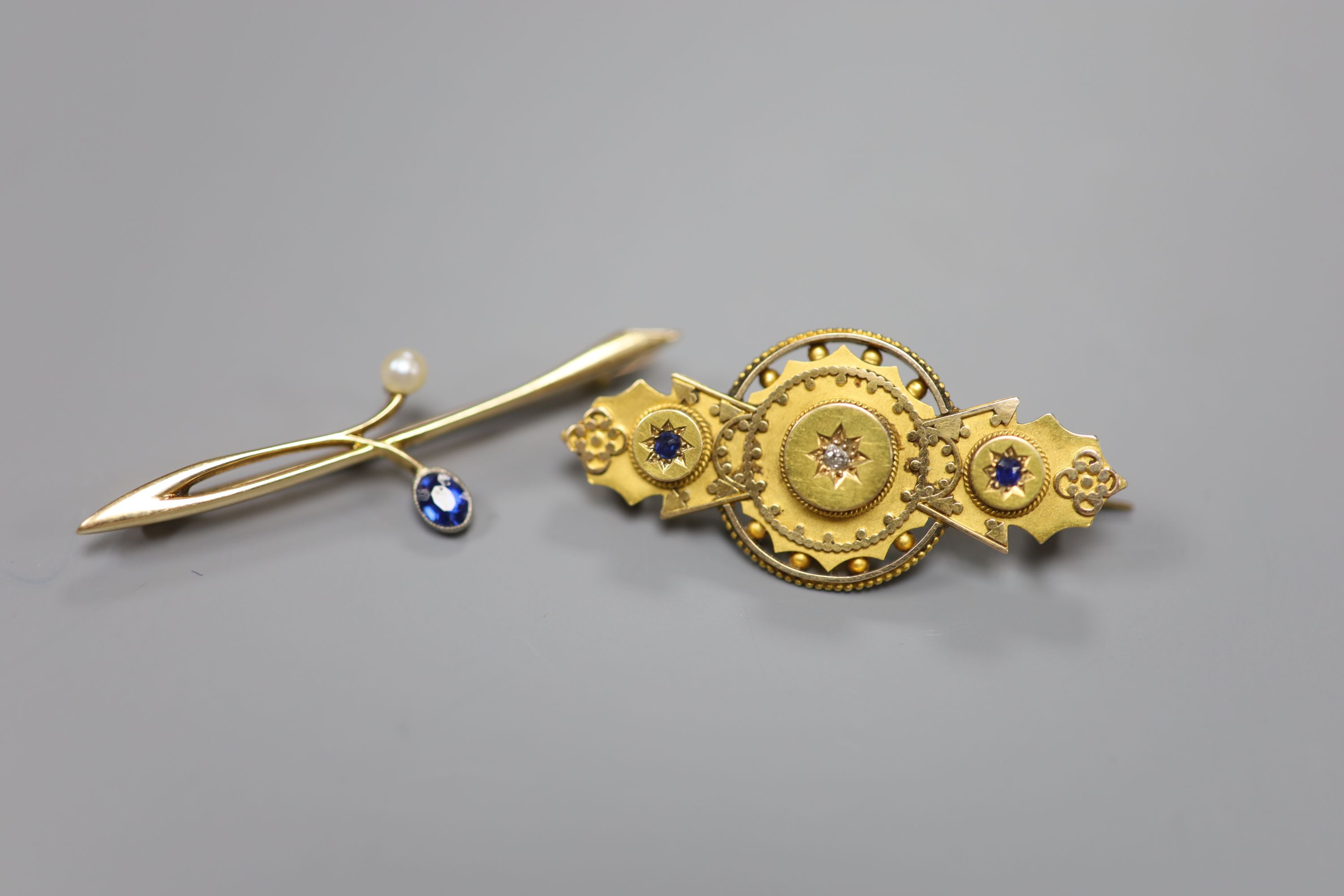 A 15ct gold, diamond and sapphire gypsy-set bar brooch and a 15ct gold foliate form pearl and sapphire set bar brooch, gross 7.5g.